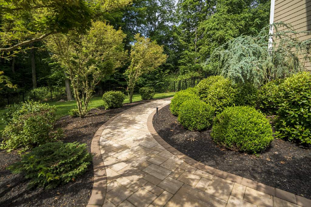 Beautiful stone walkway surrounded by well-manicured landscaping