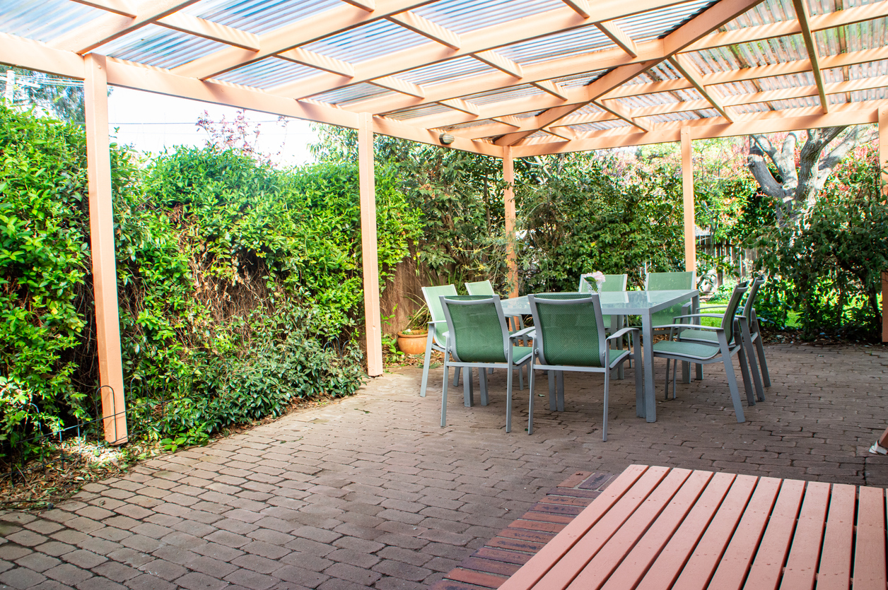 Outdoor living area with stone patio and outdoor dining table with chairs